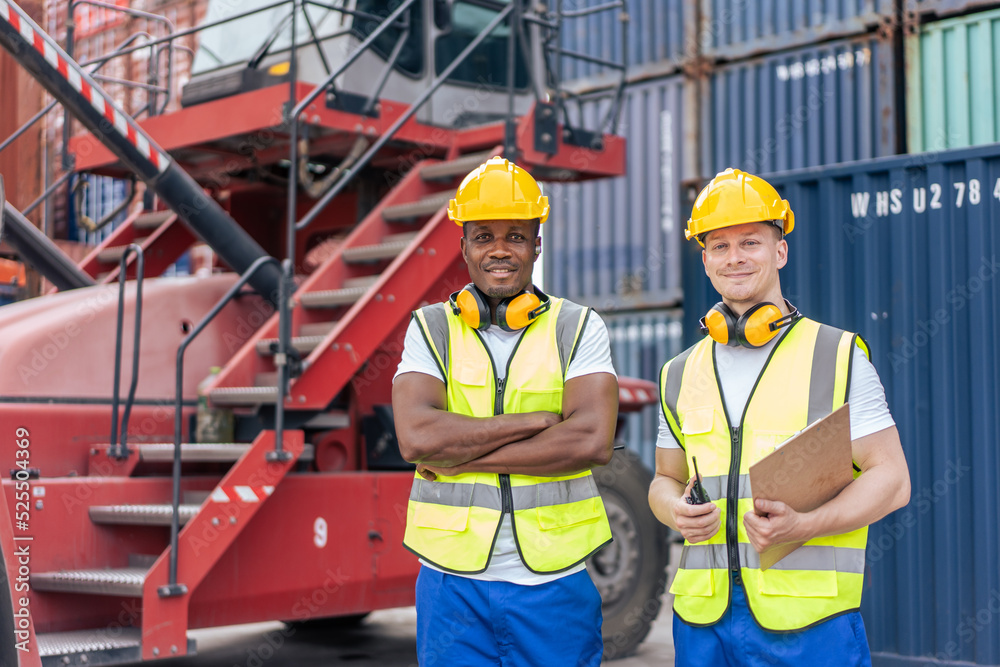 Portrait of Caucasian worker and African man work in container port. Portrait of Caucasian worker and African man work in container port.