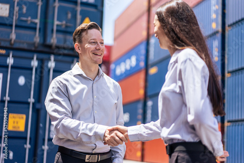 Caucasian businesswoman and businessman worker wor in container port