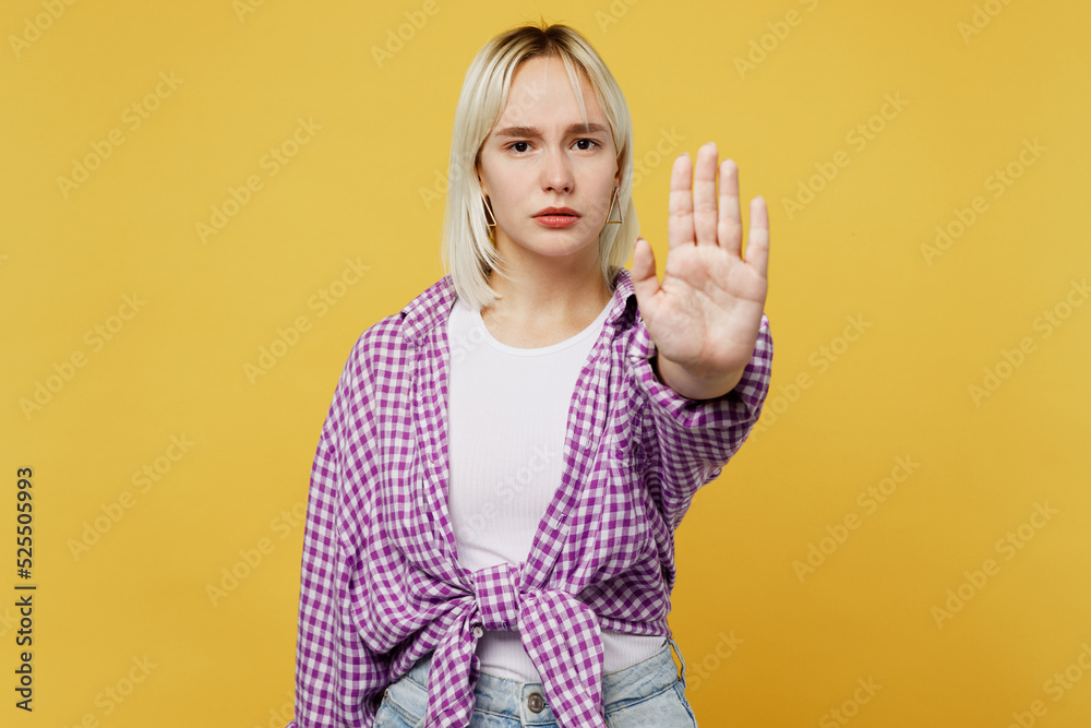 Young sad blonde woman 20s she wear pink tied shirt white t-shirt look camera showing stop gesture with palm reject refuse isolated on plain yellow background studio portrait People lifestyle concept Young sad blonde woman 20s she wear pink tied shirt white t-shirt look camera showing stop gesture with palm reject refuse isolated on plain yellow background studio portrait People lifestyle concept