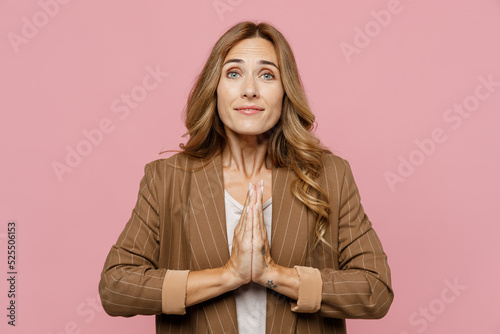 Εκτύπωση καμβά Young asking successful employee business woman 30s she wearing casual brown classic jacket hold hands folded in prayer gesture, begging about something isolated on plain pastel light pink background