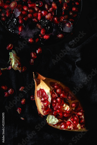 Fresh and red pomegranate on dark background