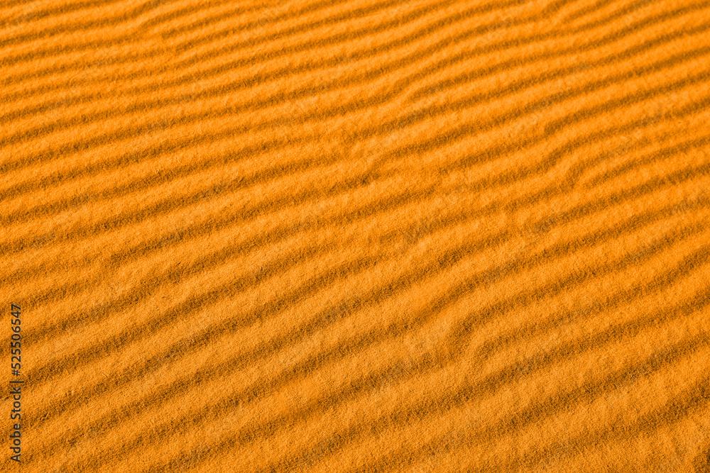 Closeup view of orange sand dune in desert as background Closeup view of orange sand dune in desert as background