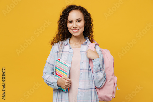 Photography Young smart happy satisfied fun black teen girl student she wear casual clothes backpack bag hold books look camera isolated on plain yellow color background