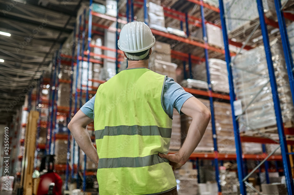 Storehouse employee inspecting merchandise on the pallets Storehouse employee inspecting merchandise on the pallets