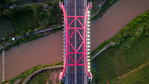 Aerial view of the Kalikuto Bridge, an Iconic Red Bridge at Trans Java Toll Road, Batang when sunrise. Central Java, Indonesia, August 24, 2022 photo