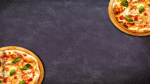 Pizzas on Dark Taple Top Background - With Copyspace photo