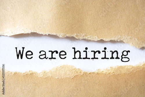 we are hiring written under torn paper. Human resource concept, strategy, plan, planning.