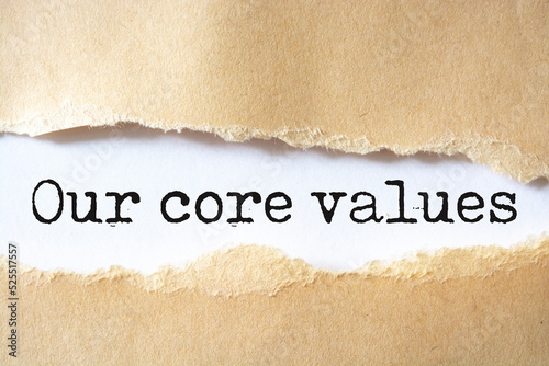 Our core values symbol. Words 'Our core values' appearing behind torn brown paper.