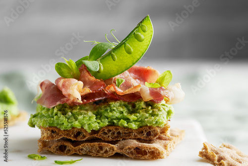 Crispbreads with pea spread, with ham, pea sprouts. Delicious breakfast, lunch, dinner or snack. Knackebrot. Copy space	