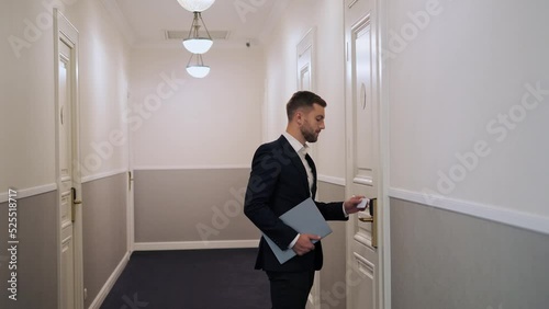 Wallpaper Mural Business man dressed in formal suit uses electronic key to open the door in a modern hotel. Man unlocks the door. Hotel guest using card key for opening hotel room. Hotel business technologies. Torontodigital.ca