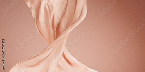 Luxury silk fabric floating in empty studio space. Pastel satin cloth wave on pink background. Beauty, fashion and cosmetic product showcase display. Premium brand mockup template. photo