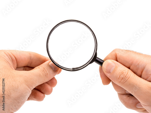 Male hands hold a magnifying loupe with an empty space to insert an image. Isolated on white background.