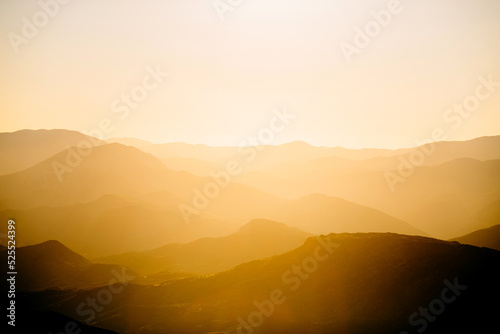Beautiful orange sunset in mountains. Travel background.