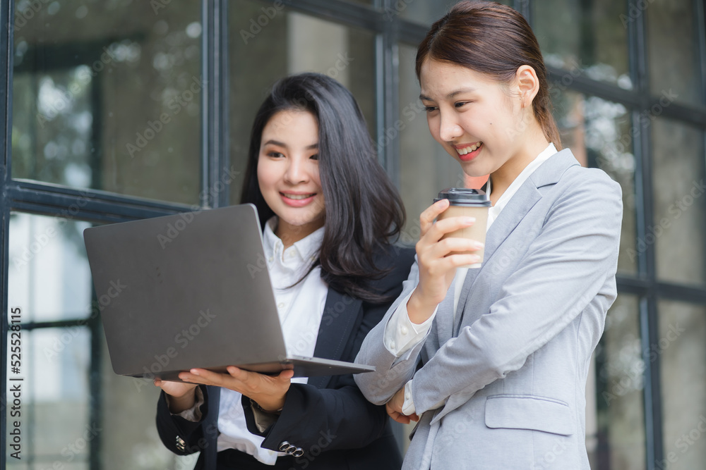 Two business Asian young women working together with laptop computer in the modern office. Two business Asian young women working together with laptop computer in the modern office.