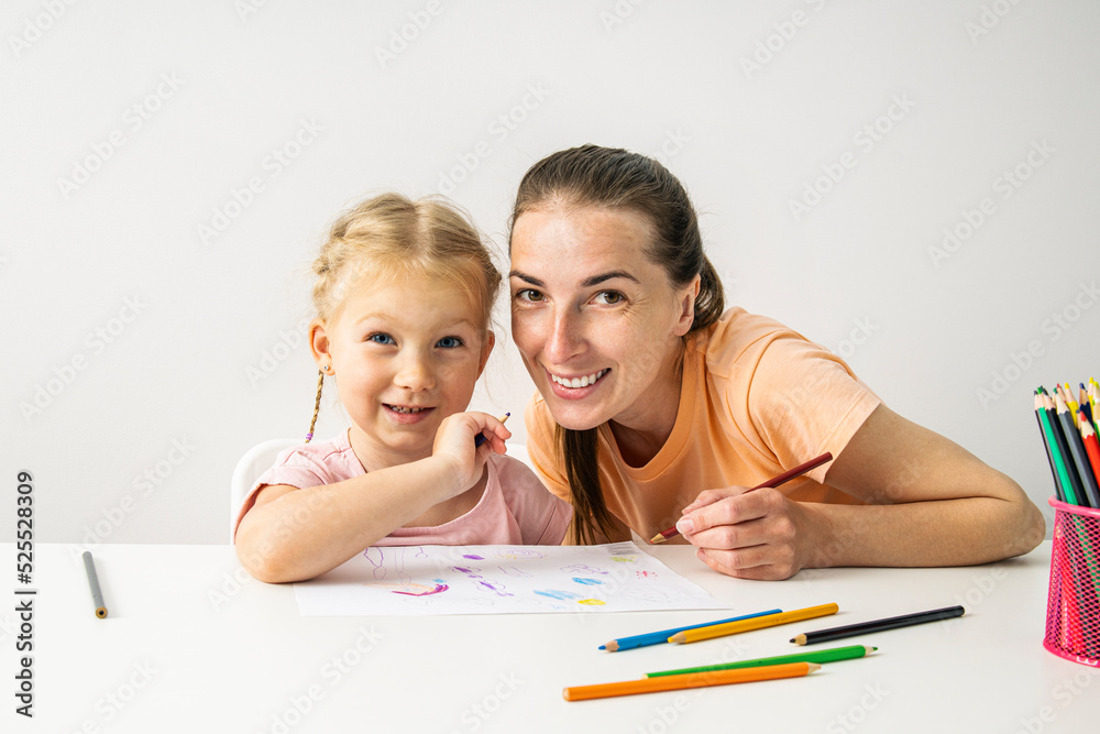 Smiling girl child and mother are painted with colored pencils on paper Smiling girl child and mother are painted with colored pencils on paper