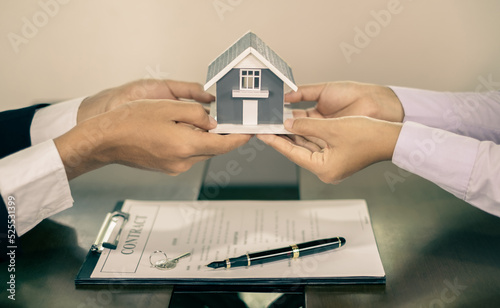 The real estate agent gives the house to a new owner's client after completing the signing of the lease and formally completing home insurance. Rental and insurance concepts