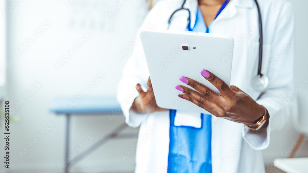 Female Doctor Wearing Scrubs In Hospital Corridor Using Digital Tablet. Doctor with stethoscope in white coat holding tablet, showing medical information, diagnosis, isolated on white background, Female Doctor Wearing Scrubs In Hospital Corridor Using Digital Tablet. Doctor with stethoscope in white coat holding tablet, showing medical information, diagnosis, isolated on white background,
