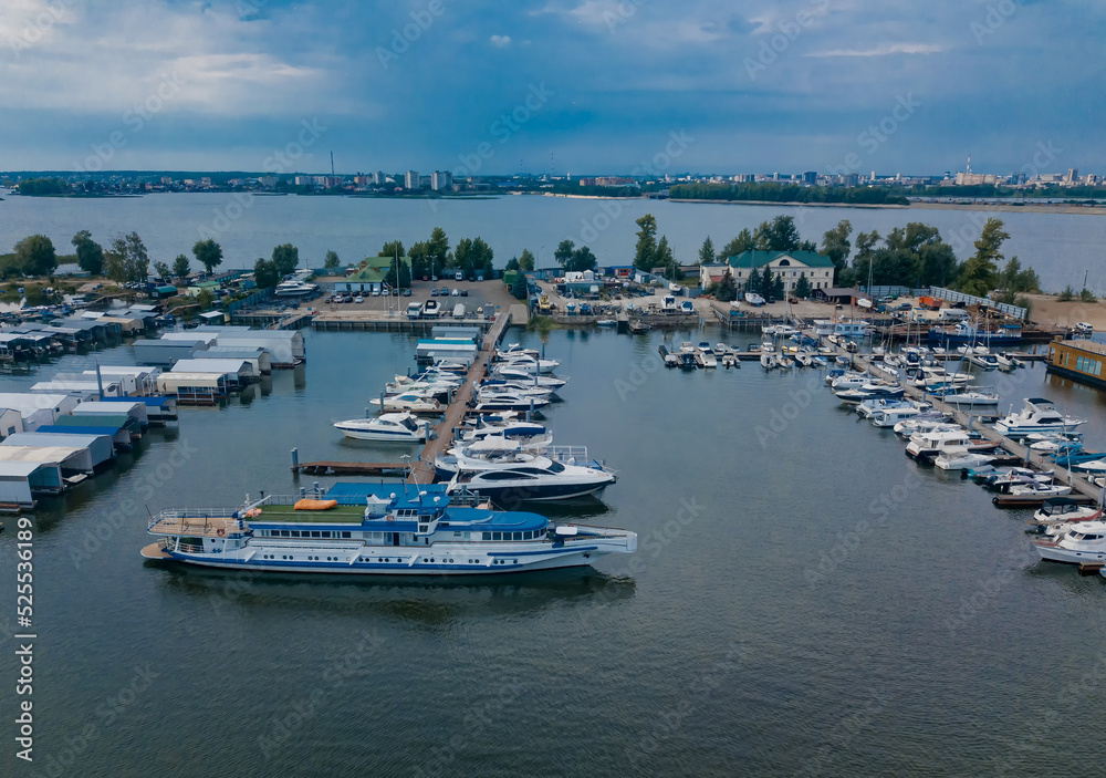 Aerial view of yacht club and marina. Colorful boats and yachts. Top view from drone of harbor with yacht, motorboat and sailboat. Transportation and travel background