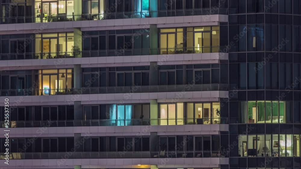 Windows lights in modern office and residential buildings timelapse at night. Multi-level skyscrapers with illuminated apartments inside Windows lights in modern office and residential buildings timelapse at night. Multi-level skyscrapers with illuminated apartments inside