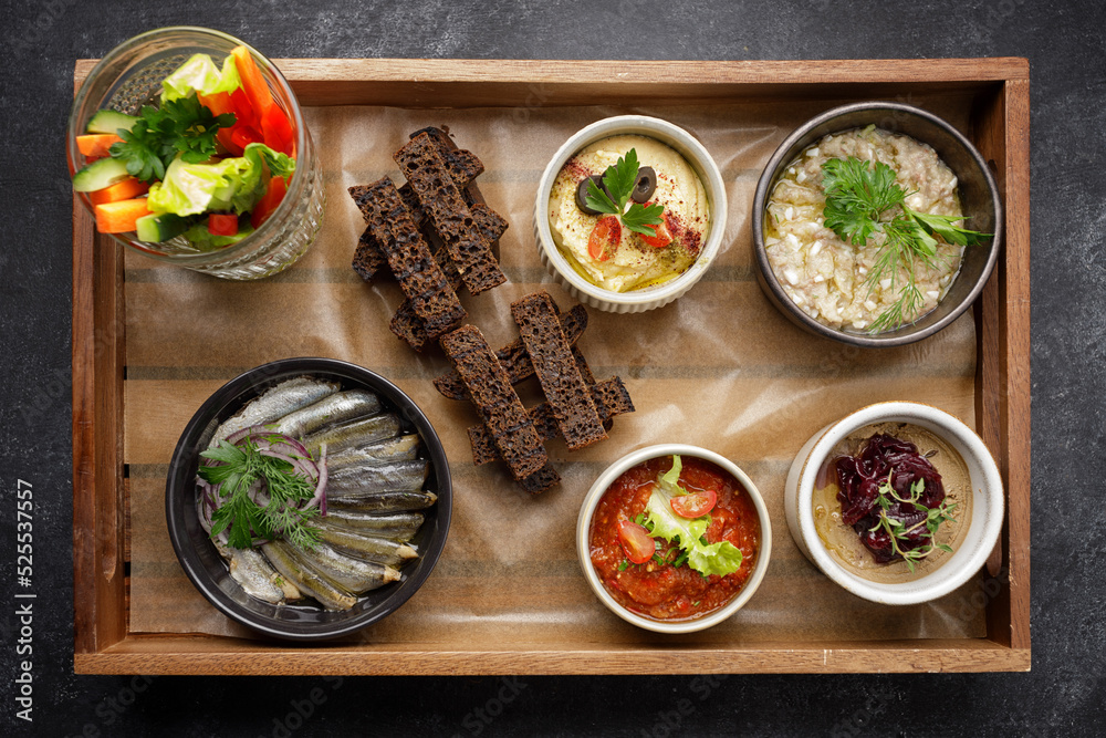 Various appetizers, snacks from vegetables on a wooden board