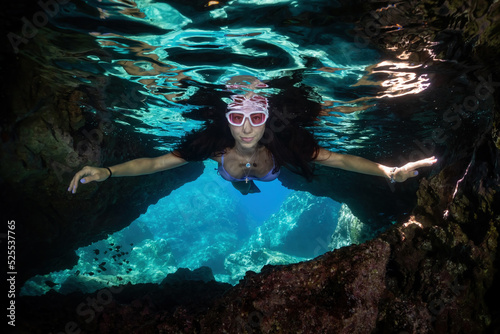 freediver girl in the cave. underwater shoot. photo