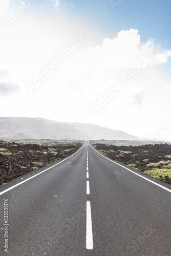 Straight asphalt roadway in mountainous valley photo