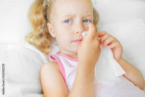 The child wipes his nose with a napkin. Nasal hygiene in case of illness.