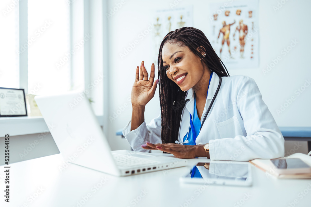 Young female doctor talking while having conference call at her office over a computer. Copy space. Head shot portrait woman doctor talking online with patient, making video call. Young female doctor talking while having conference call at her office over a computer. Copy space. Head shot portrait woman doctor talking online with patient, making video call.