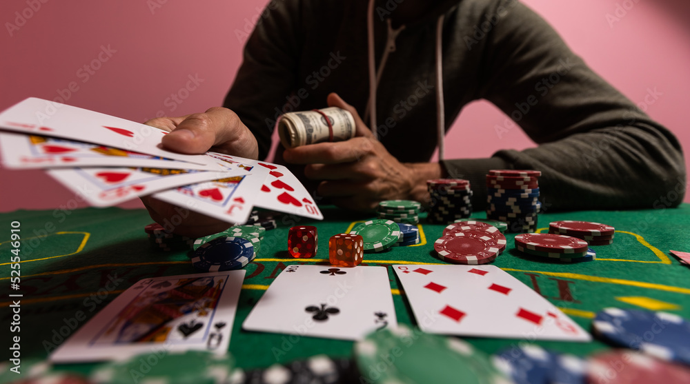 Obraz premium Casino, gambling and entertainment concept - stack of poker chips on a green table.