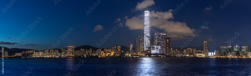 Blue night.  Deep blue sky and sea just after sunset with light reflected from a skyscraper