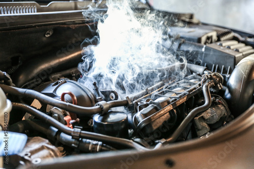 car engine overheating close up. vehicle engine in smoke. smoke or steam from a vehicle engine © Петр Смагин