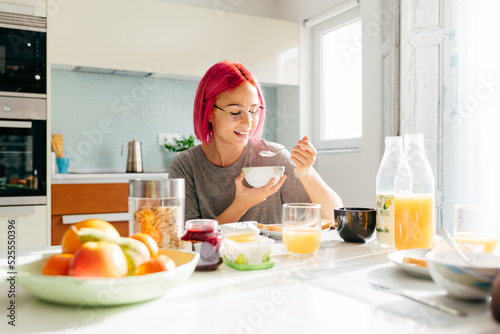Young lady having healthy breakfast at home photo