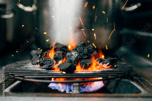 Burning coal on grill photo