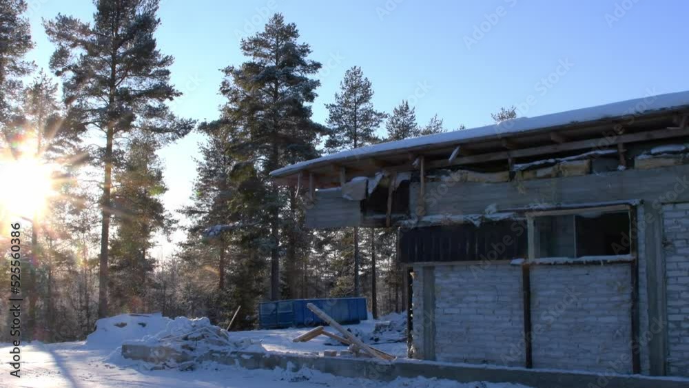 Demolition site at sunny winter day. Truck tire tracks are visible in snow cover. Tilt up. Demolition site at sunny winter day. Truck tire tracks are visible in snow cover. Tilt up.
