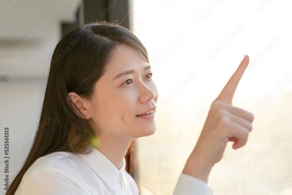 woman look at window and pointing on something woman look at window and pointing on something
