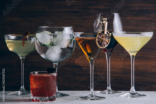 Set of alcohol cocktails in glasses on table photo