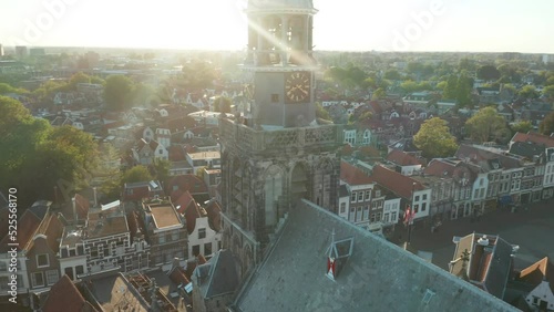 Sint Janskerk Clock Tower On Sunny Day With Gouwekerk Chuch Background In Netherlands. Aerial Drone Orbiting photo