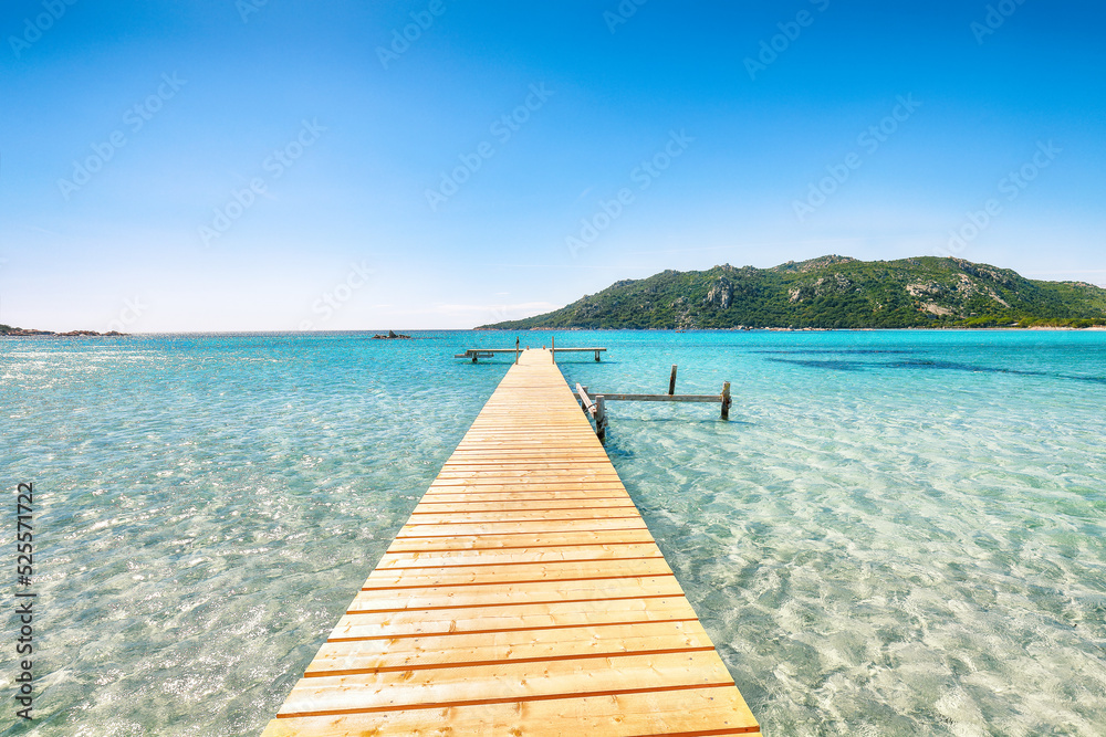 Astonishing landscape with wooden pier on Santa Giulia beach.