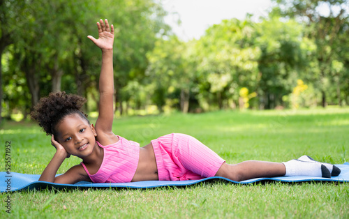 Happy yoga African American kid girl at garden 