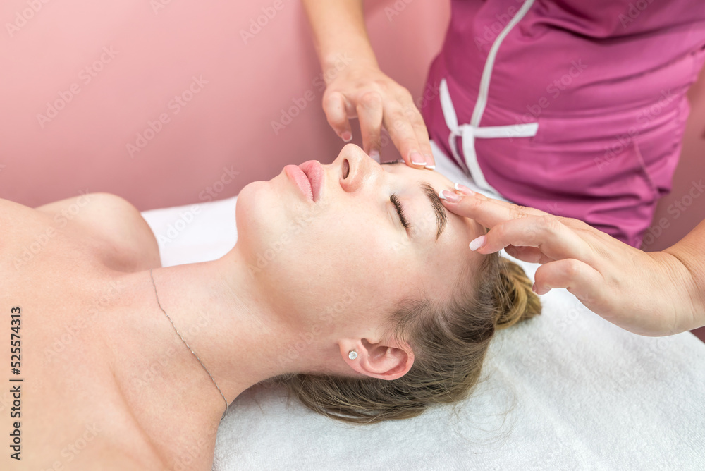 Beautiful girl doing facial massage Beautiful girl doing facial massage