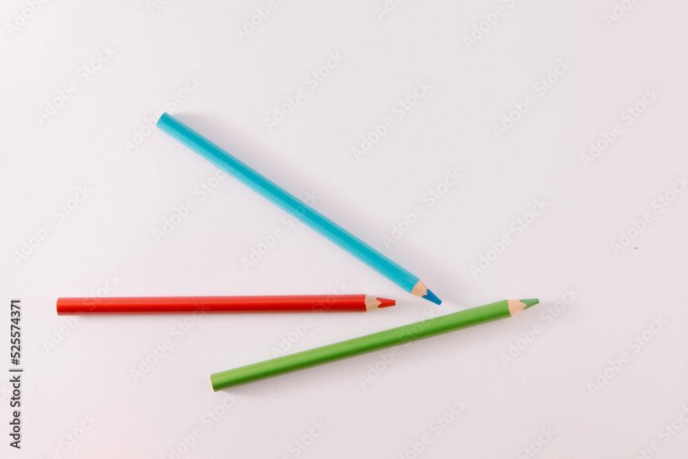 Colored wooden pencils on a gray background, minimal back to school concept, red, green, blue Colored wooden pencils on a gray background, minimal back to school concept, red, green, blue