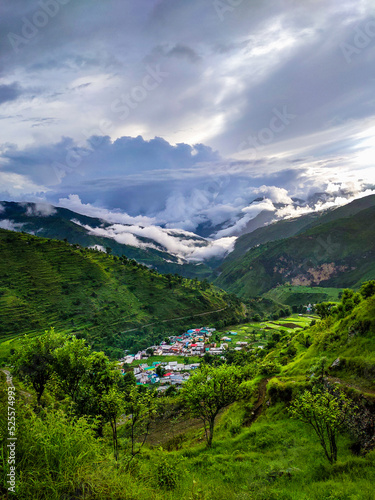 A wide angle shot of a village in the mountains of Lower Himalayan region of Uttarakhand State, India. photo