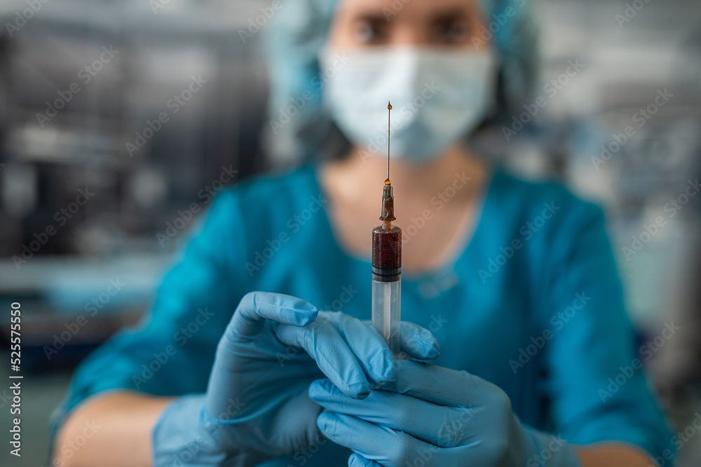 doctor wearing blue uniform with glove full virus protection holding syringe with medicine doctor wearing blue uniform with glove full virus protection holding syringe with medicine
