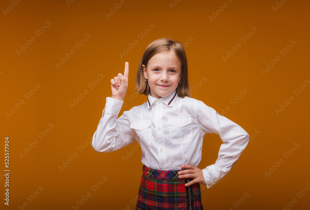 close-up portrait, cute attractive knowledgeable creative genius smart cheerful cheerful schoolgirl girl pointing up, isolated on yellow background close-up portrait, cute attractive knowledgeable creative genius smart cheerful cheerful schoolgirl girl pointing up, isolated on yellow background