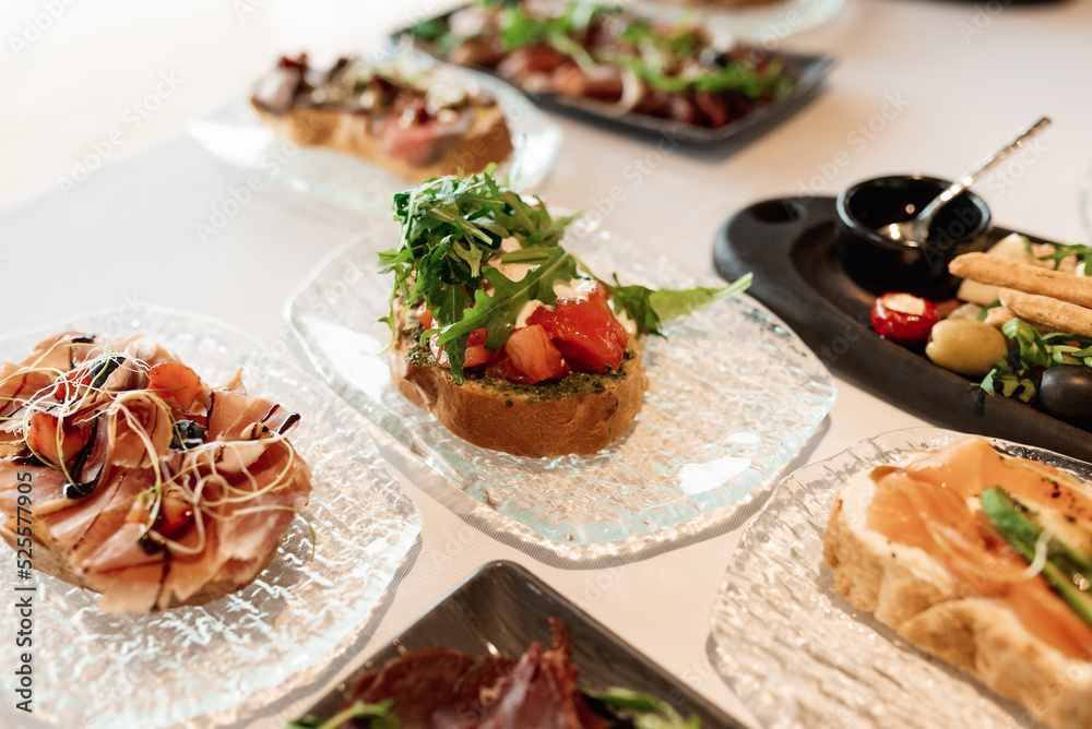 bruschetta square set top view. Brushetta set for wine. Variety of small sandwiches with prosciutto, tomatoes, cheese, herbs bruschetta square set top view. Brushetta set for wine. Variety of small sandwiches with prosciutto, tomatoes, cheese, herbs