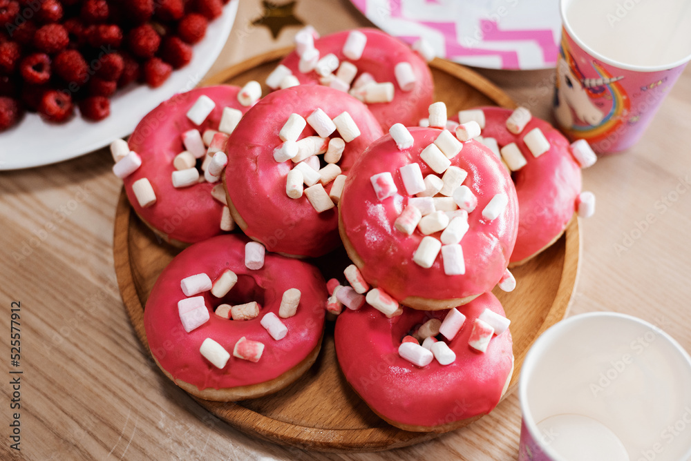 Donuts with sprinkles on pink background. Sugar, calories, homemade sweets concept. Donuts with sprinkles on pink background. Sugar, calories, homemade sweets concept.