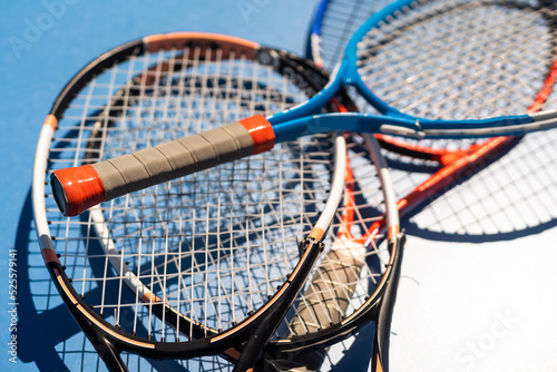 broken tennis rackets blue tennis court