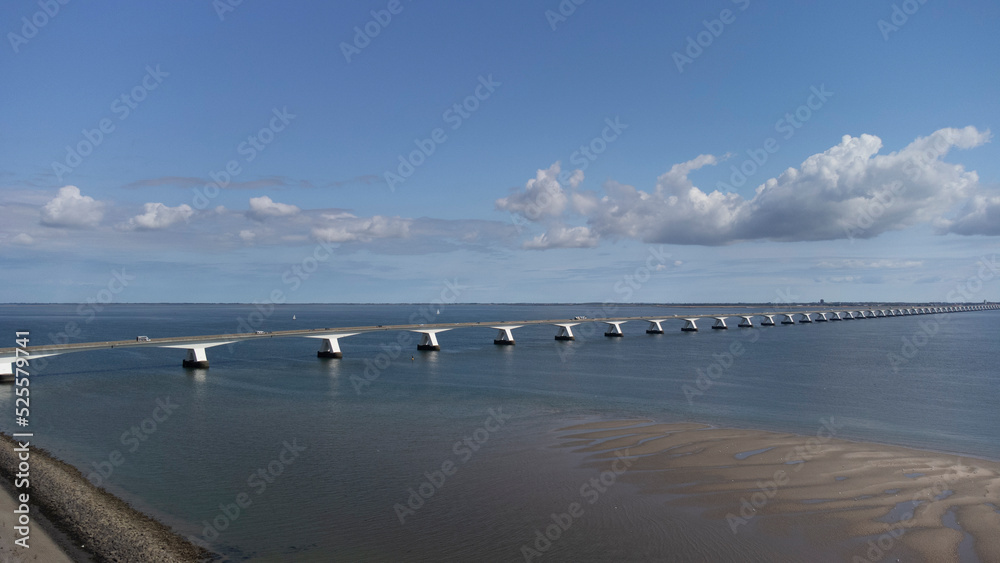 View on longest bridge in the Netherlands, Zealand bridge spans Eastern Scheldt estuary, connects islands Schouwen-Duiveland and Noord-Beveland in province of Zeeland, water of Oesterschelde and boats