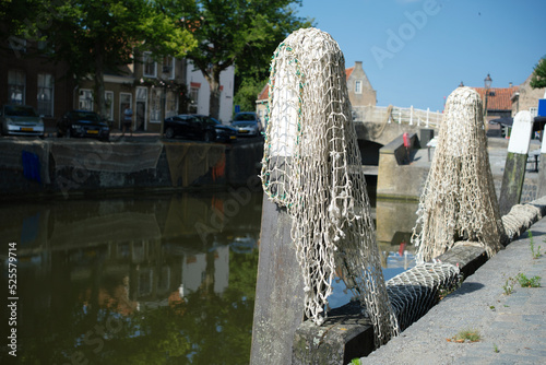 Goedereede, The Netherlands. Small harbor in the picturesque medieval town of Goedereede overlooking a beautiful old Gothic church tower that was used as a lighthouse at the time. photo