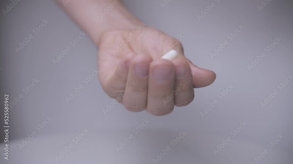 man holding pills in his hand slow mo man holding pills in his hand slow mo